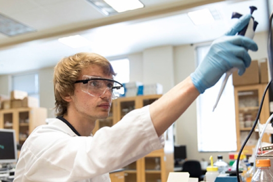 photo of young man in lab with goggles