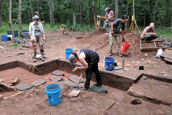 students working on archeological excavation