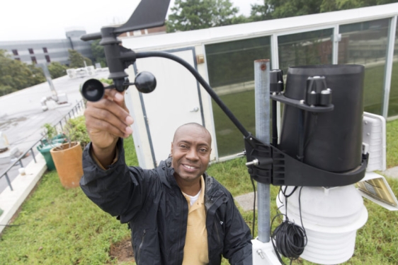 photo of man with wind gauge equipment, outside