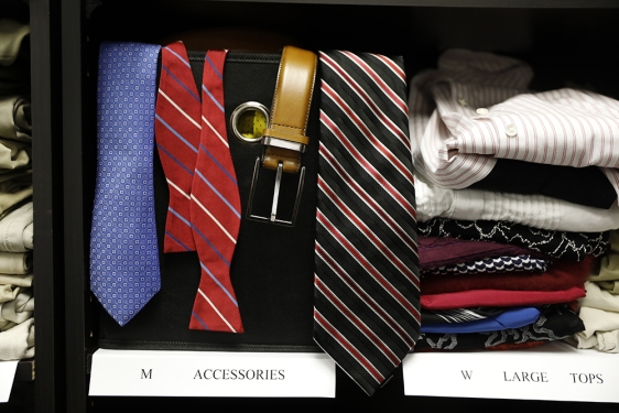 photo of ties, belts and folded shirts