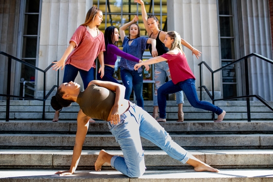 Photo of six women dancers posed on steps