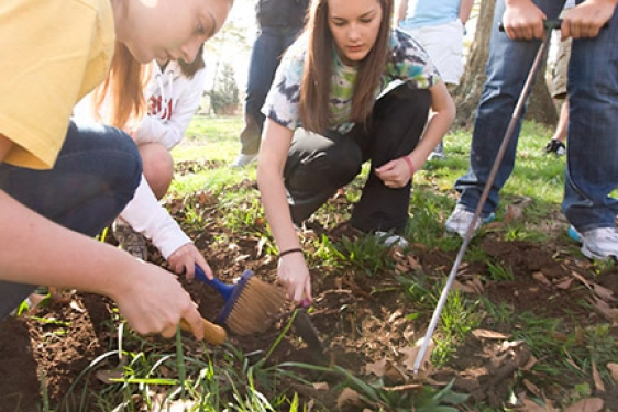 students outdoors on a dig