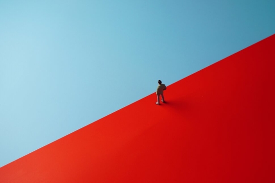 graphic with semaphore color field of blue and red, human figure at center