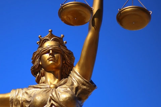 photo of statue of Lady Justice (Goddess), with blue sky