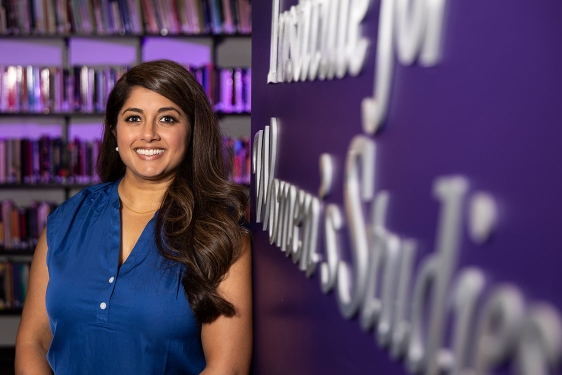 photo of woman and sign, books in background