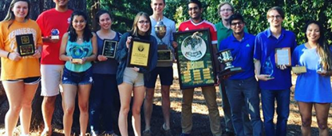 students with plaques, trophies