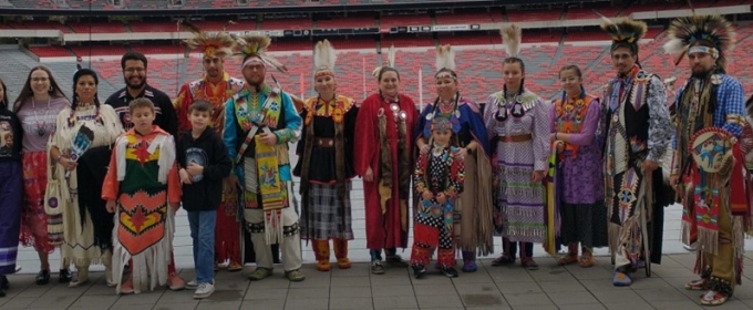 photo of Native Americans in indigenous dress at stadium