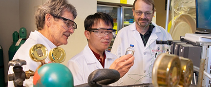 photo of three men in a lab