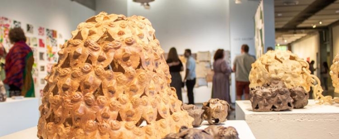 photo of sculpture and people at an art exhibition