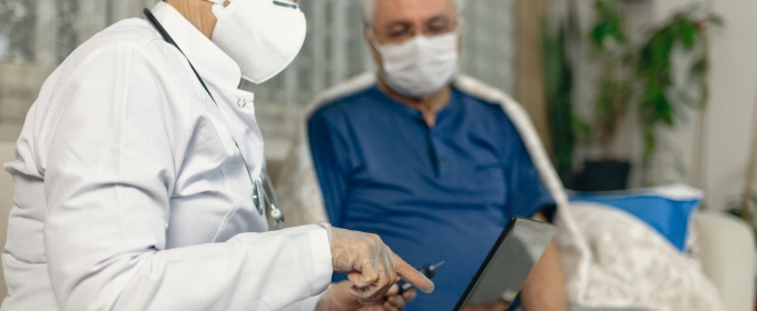 photo of masked nurse with masked patient
