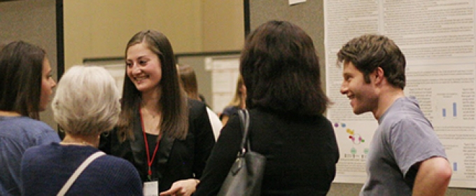 students talking near a poster