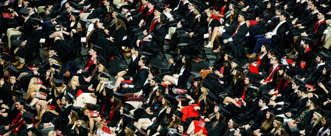 photo of seated people in caps and gowns