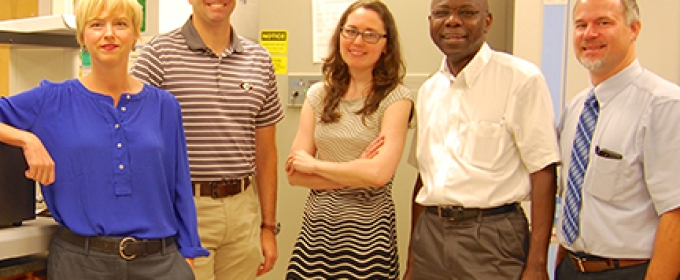 photo of four people in a lab