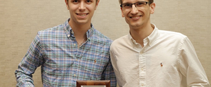 photo of two men with plaque and steins 