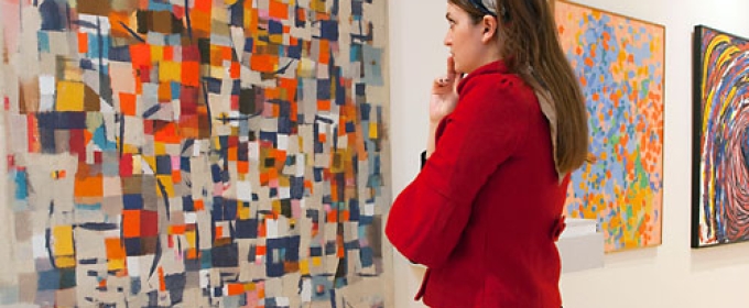 photo of woman studying abstract art