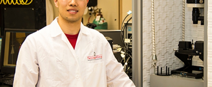 student in lab coat in lab