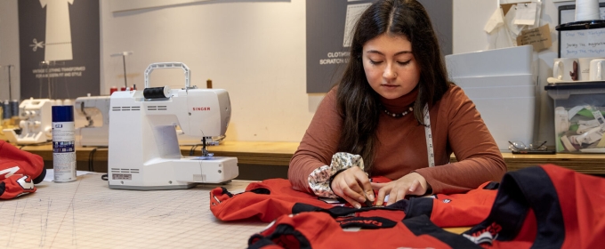 photo of woman sewing a red jersey