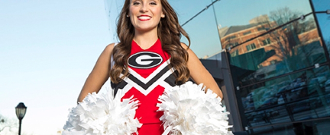 photo of cheerleader in front of coliseum