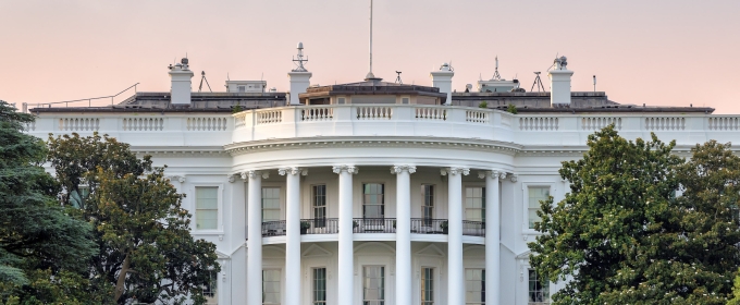 photo of U.S. White House, with flag, day