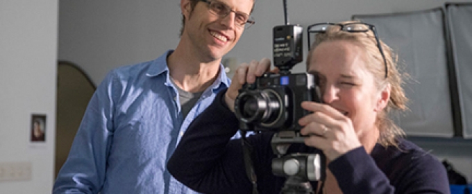 photo of man and student with camera