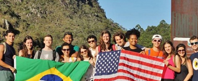photo of students holding Brazilian and American flags