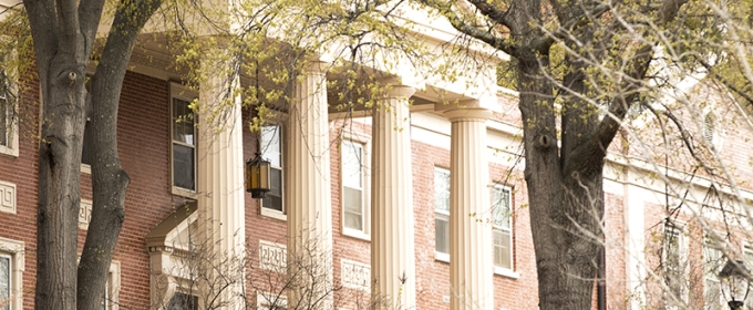 photo of building portico, with spring blooms