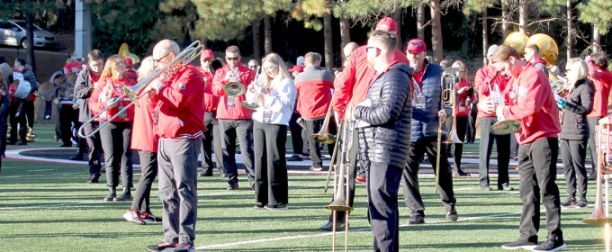 photo of people on field with band instruments