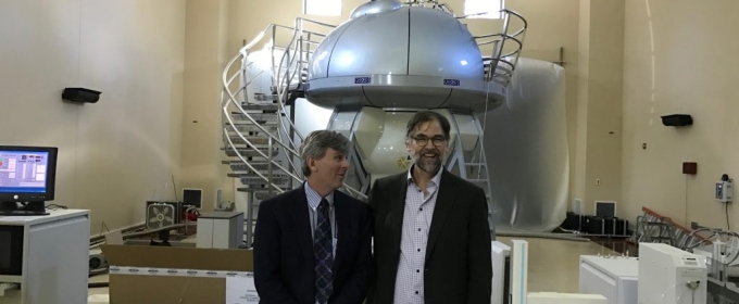 photo of men with NMR machine in background 
