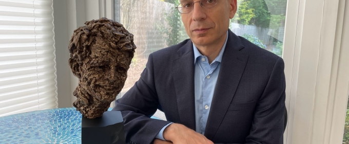 photo of man with bust sculpture