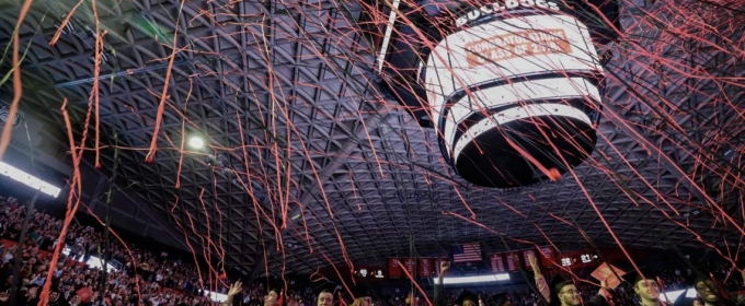 photo of indoor commencement ceremony celebration, with streamers