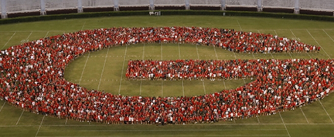 photo of students forming a G on the stadium field