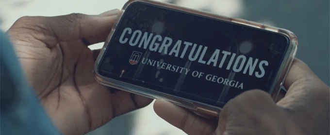 photo of hands holding a cell phone with congratulations