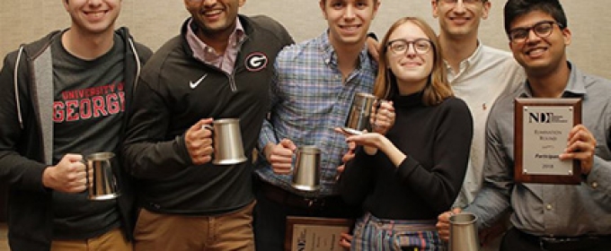 photo of six students holding award cups