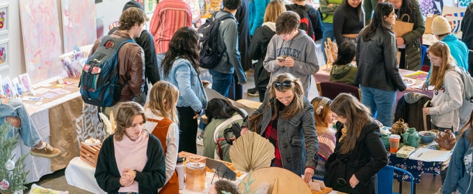 photo of people, tables and objects at an artist's market
