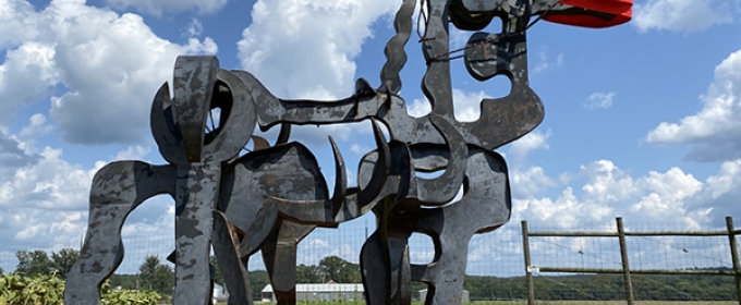 photo of iron sculpture, blue sky