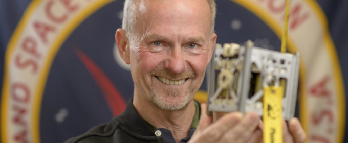 photo of man holding a phonesat
