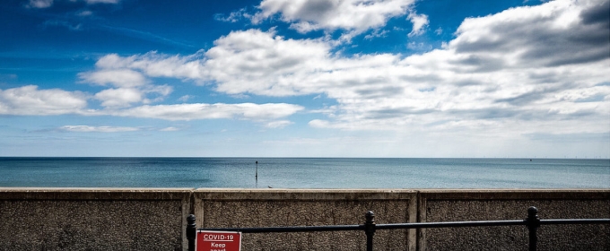 photo of open water, wall and red sign