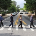 photo of four people walking in crosswalk, day